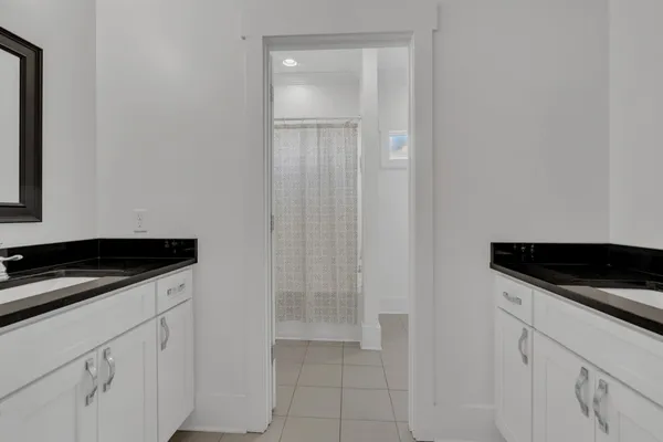 a bathroom with double sink and a mirror