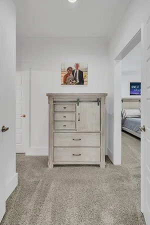 a spacious bedroom with a bed and a cabinets