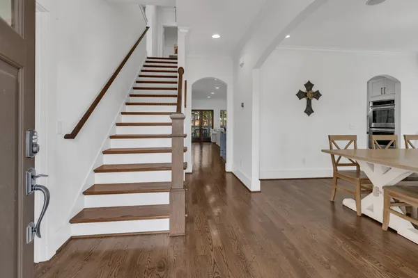 a view of entryway and hall with wooden floor