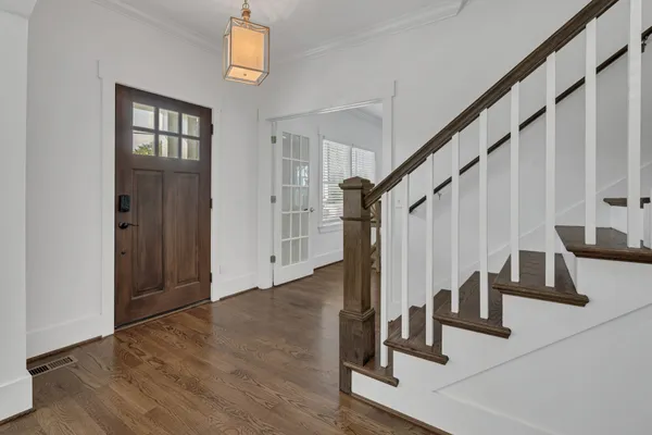a view of staircase with white walls and railing