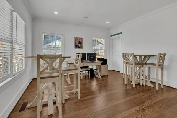 a living room with furniture and a wooden floor
