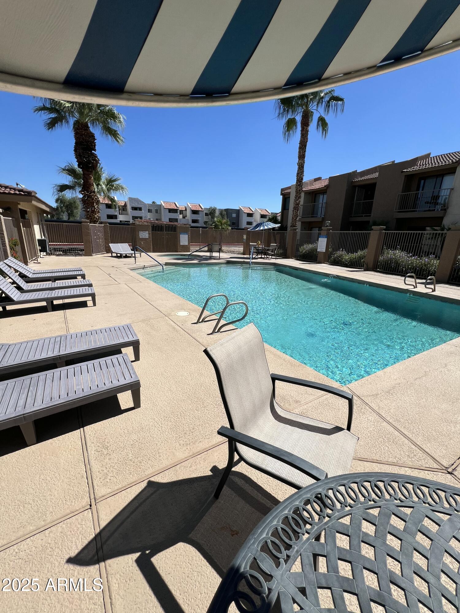 1111 East University Drive, Unit 230 Tempe, AZ 85288 - Photo 13 of 18 a swimming pool with outdoor seating and yard