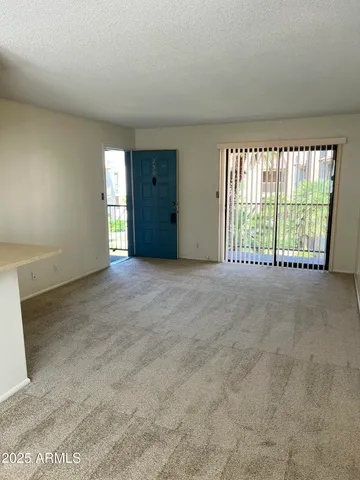 an empty room with windows and city view