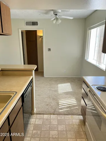a view of a kitchen with a sink and a stove top oven