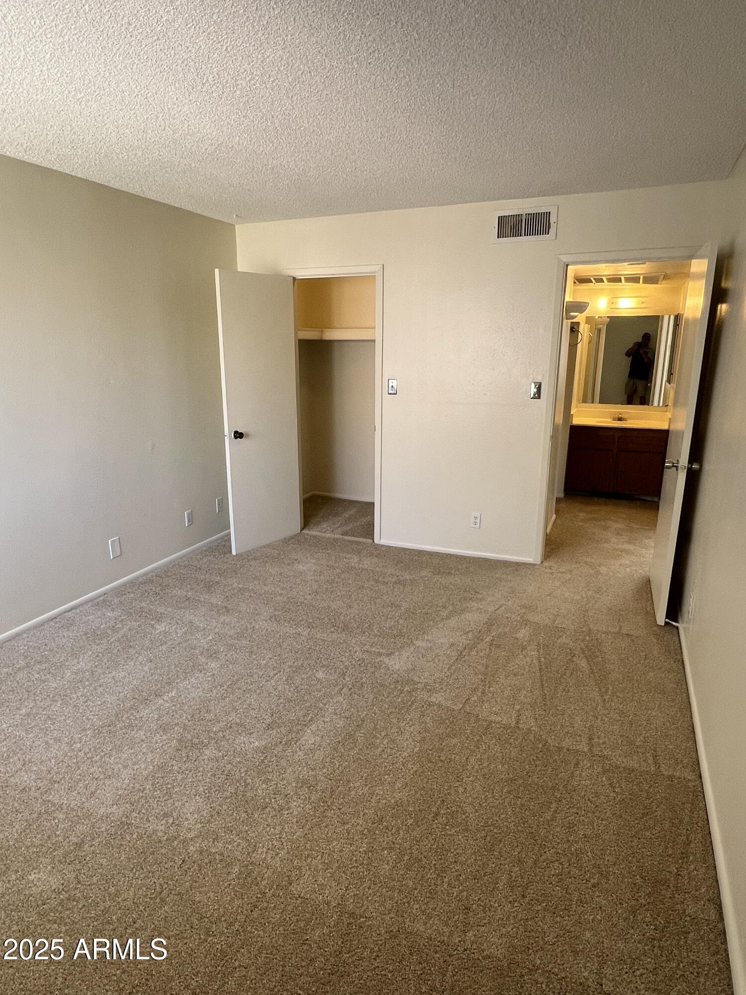 1111 East University Drive, Unit 230 Tempe, AZ 85288 - Photo 5 of 18 a view of an empty room and a kitchen