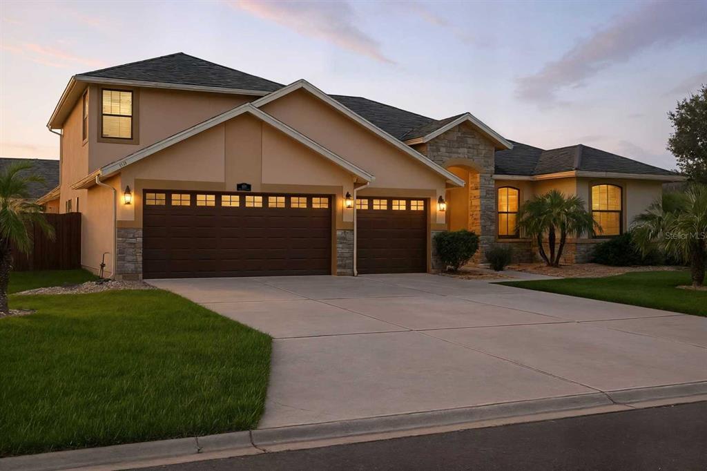 a front view of a house with a yard and garage