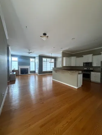 a view of a kitchen with a sink and a large window