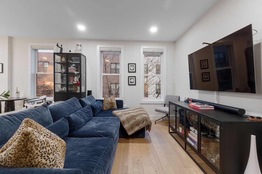 202 Maverick Street, Unit 301 Boston, MA 02128 - Photo 11 of 28 a living room with furniture and a flat screen tv
