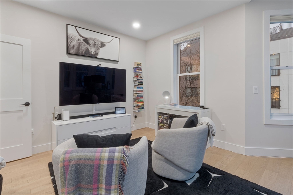 202 Maverick Street, Unit 301 Boston, MA 02128 - Photo 16 of 28 a living room with furniture and a flat screen tv