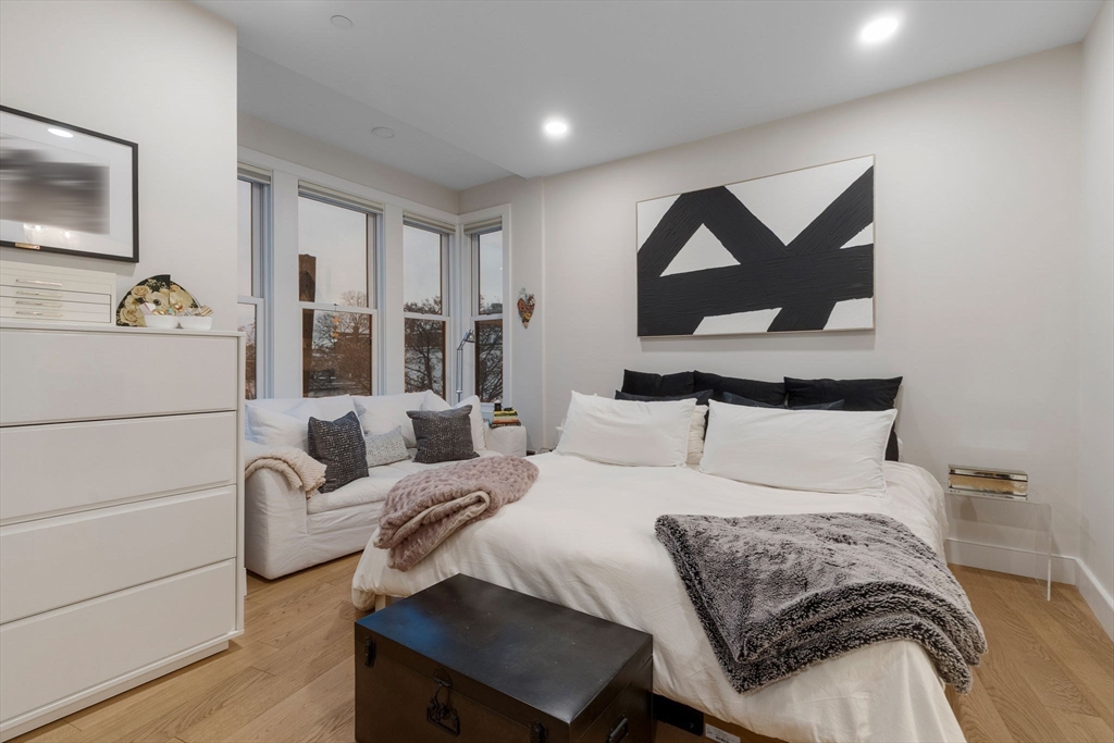 202 Maverick Street, Unit 301 Boston, MA 02128 - Photo 17 of 28 a bedroom with a bed and a painting on the wall