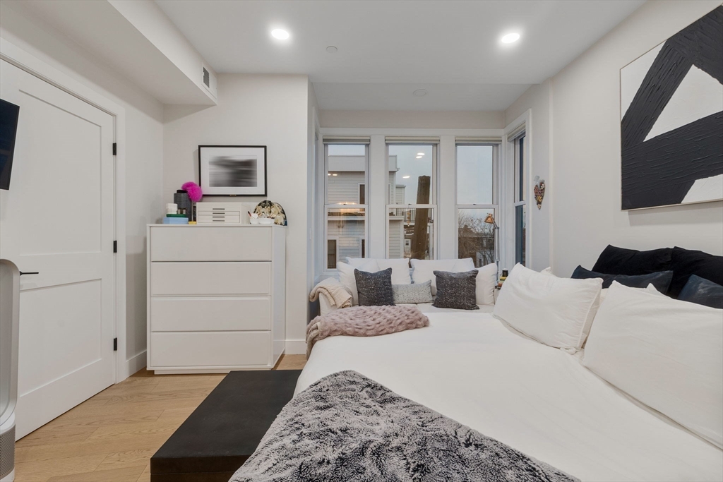 202 Maverick Street, Unit 301 Boston, MA 02128 - Photo 18 of 28 a bedroom with a bed and a flat screen tv