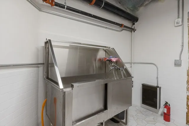 a front view of a residential apartment building with cars parked