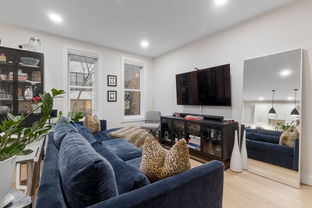 202 Maverick Street, Unit 301 Boston, MA 02128 - Photo 10 of 28 a living room with furniture and a flat screen tv