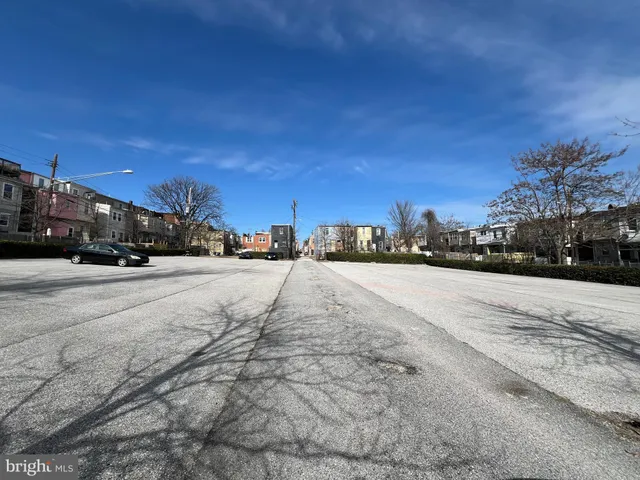 a view of road with a cars parked in front of it