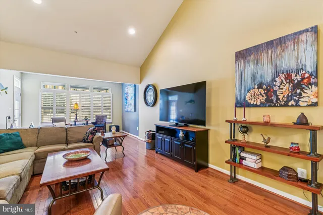 a view of a livingroom with lounge chair and a large window