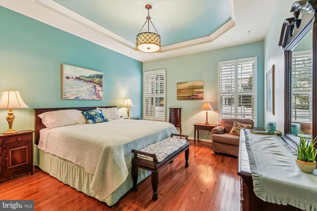 a bedroom with bed and wooden floor