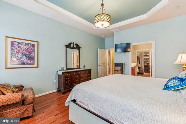 a bedroom with a bed and a dresser in it