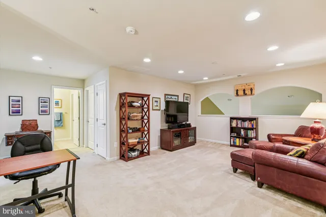 a living room with furniture and a lamp