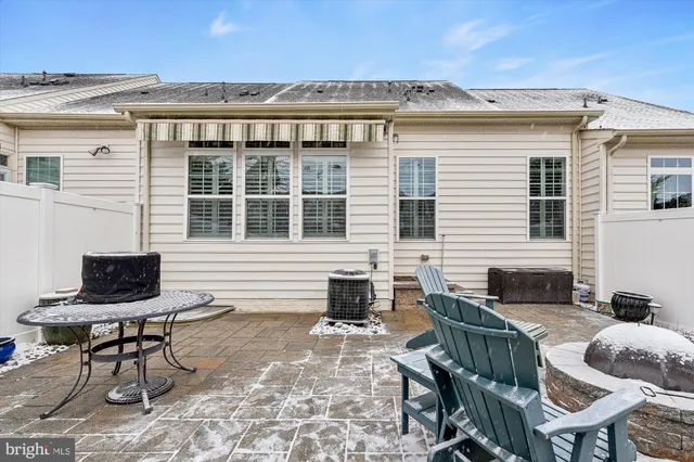 a view of a patio with couches chairs and potted plants