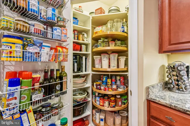 a view of a dining room with furniture a chandelier and wooden floor
