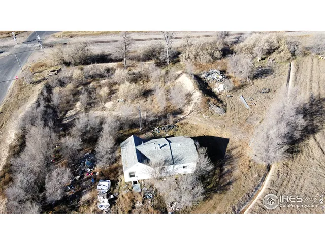 a black and white photo of a green field