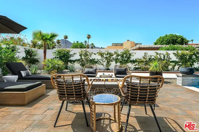 a view of an outdoor sitting area with furniture and a garden