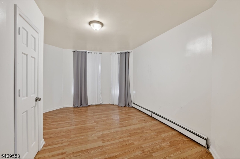 186 3rd Street, Unit 1 Newark, NJ 07107 - Photo 13 of 25 a view of a room with wooden floor