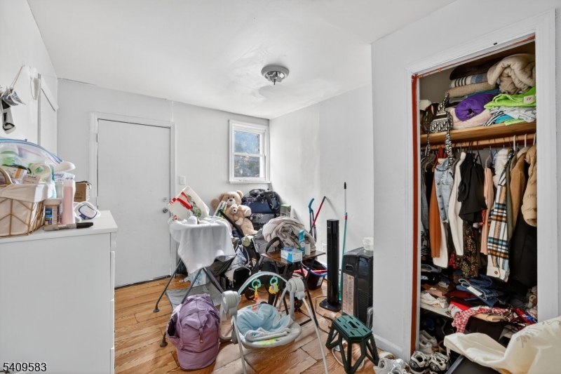 186 3rd Street, Unit 1 Newark, NJ 07107 - Photo 16 of 25 a living room with lots of furniture and a painting on the wall