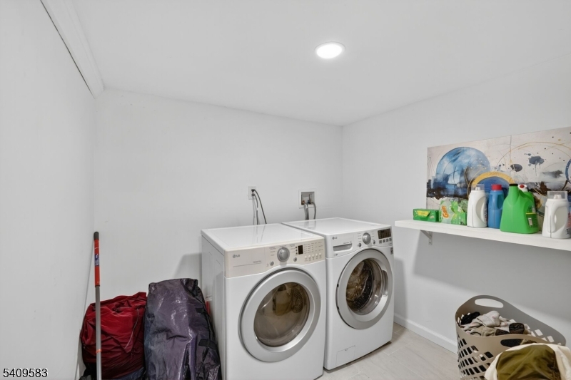 186 3rd Street, Unit 1 Newark, NJ 07107 - Photo 19 of 25 a utility room with dryer washer and shoe rack