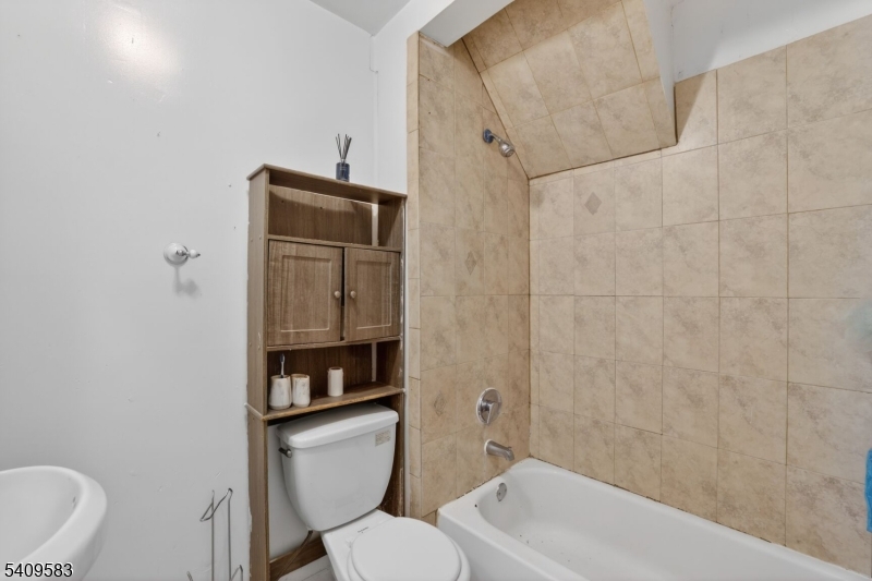186 3rd Street, Unit 1 Newark, NJ 07107 - Photo 20 of 25 a bathroom with a toilet sink and shower