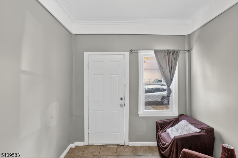 186 3rd Street, Unit 1 Newark, NJ 07107 - Photo 21 of 25 a bedroom with a bed and a window