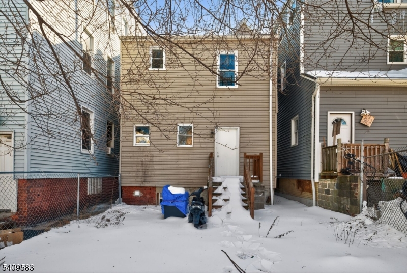 186 3rd Street, Unit 1 Newark, NJ 07107 - Photo 25 of 25 a view of a patio with couches table and chairs under an umbrella