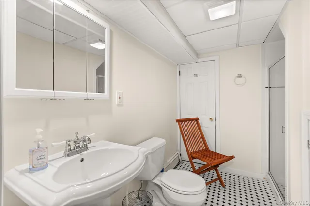 a bathroom with a toilet a sink and a mirror