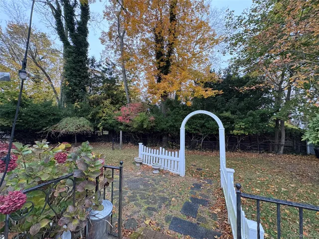 a backyard of a house with lots of green space and plants