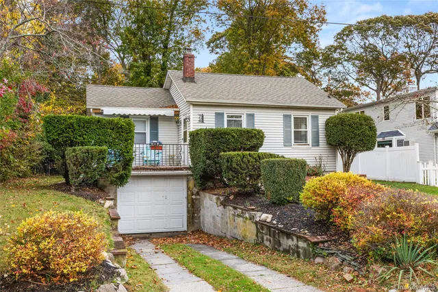 a front view of house with yard and trees around