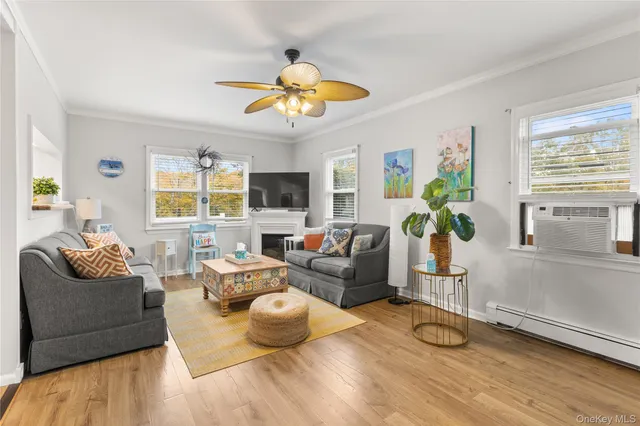 a living room with furniture a chandelier and a window