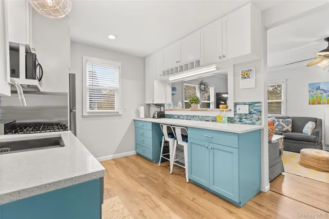 a kitchen with kitchen island granite countertop a stove and a sink