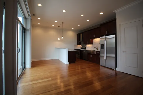 a kitchen with a refrigerator and a sink