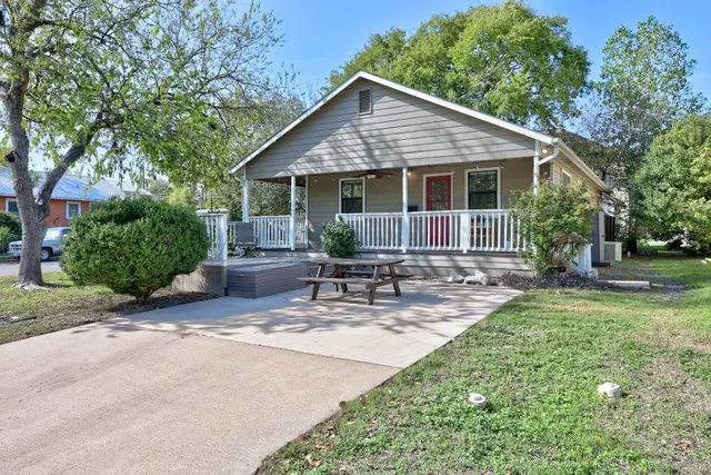 a view of a house with backyard sitting area and garden
