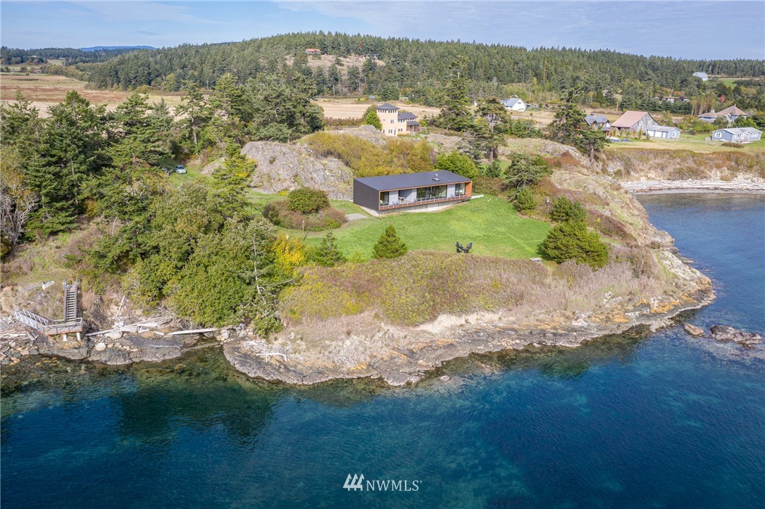 209 Hodgson Road Lopez Island, WA 98261 - Photo 1 of 20 a view of a lake with mountains in the background