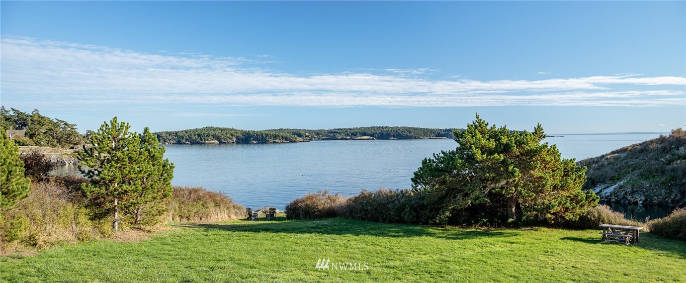 209 Hodgson Road Lopez Island, WA 98261 - Photo 13 of 20 a view of a lake with houses in the back