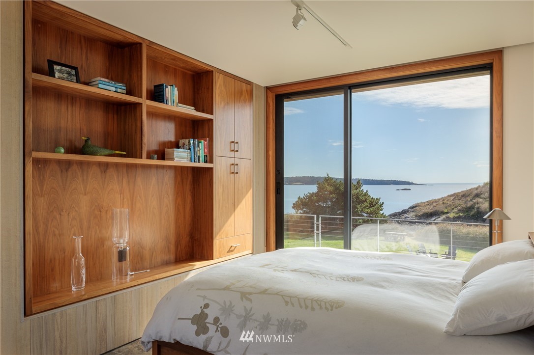 209 Hodgson Road Lopez Island, WA 98261 - Photo 14 of 20 a bedroom with a bed and a window