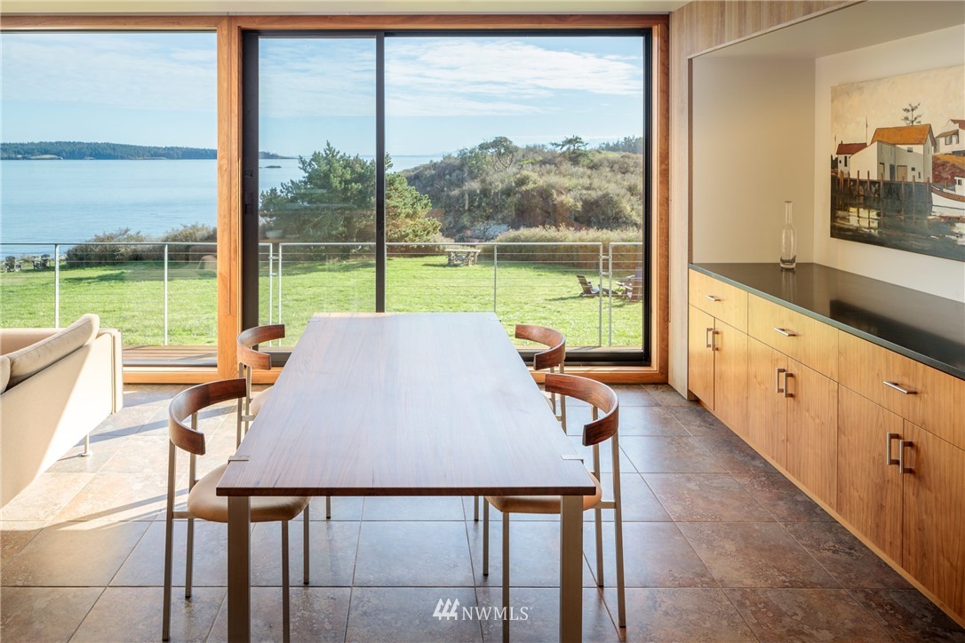 209 Hodgson Road Lopez Island, WA 98261 - Photo 5 of 20 a view of a dining room with furniture window and outside view