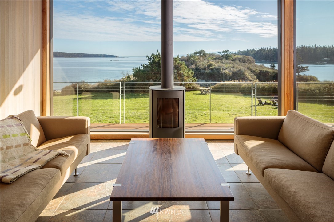 209 Hodgson Road Lopez Island, WA 98261 - Photo 8 of 20 a living room with patio couch and a floor to ceiling window
