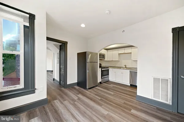 a kitchen with stainless steel appliances a refrigerator and a sink