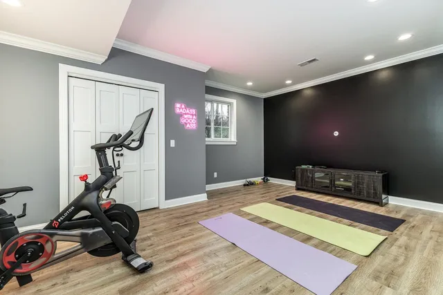 a bedroom with furniture and a gym equipment