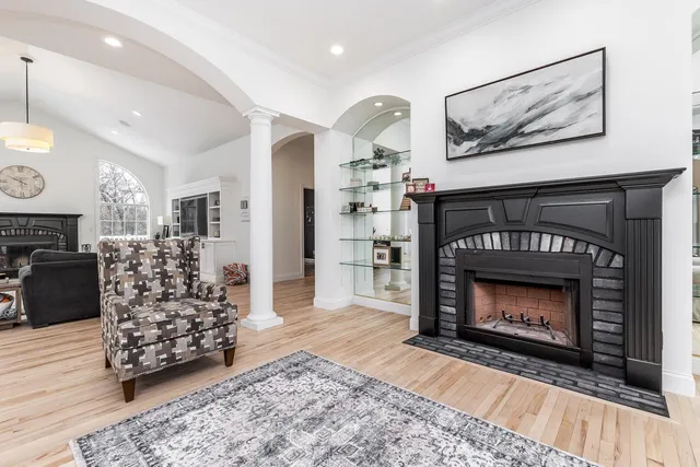 a living room with furniture a fireplace and kitchen view