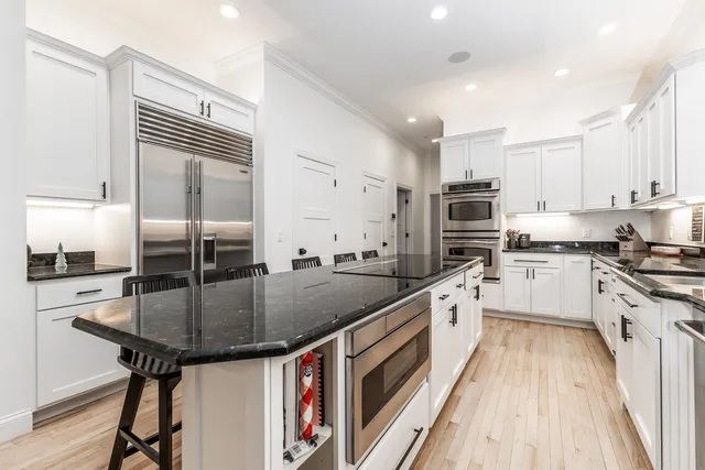 a kitchen with stainless steel appliances granite countertop counter space a sink and cabinets