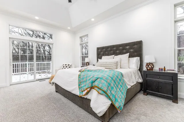 a spacious bedroom with a bed and a large window