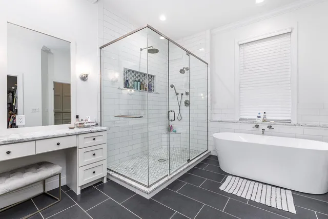 a spacious bathroom with a shower sink and mirror